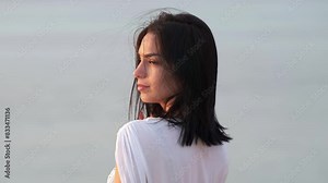 Beautiful girl enjoys a prize by the ocean. Carefree cute woman on vacation. Relaxation, travel and vacation concept. Stock Video