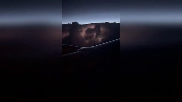 Passengers watch spectacular storm from plane window