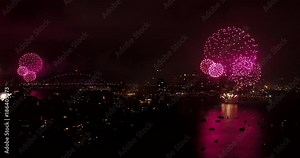 New Year Eve 2018 Fireworks in Australia over Sydney city landmarks dark at night in wide mid-air view with reflection of bright colour fireballs.