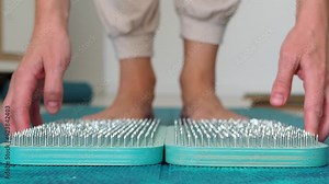 Open, lay out several sadhu boards for the practice of sadhu yoga. Preparation for standing on nails.