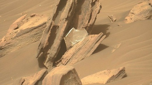NASA's Perseverance rover recently spotted landing debris caught in a jagged rock. It's thermal material the space agency used to protect the Perseverance spacecraft from extreme temperatures as it journeyed to Mars and plummeted through the Martian atmosphere. | Mashable