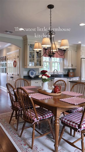 Red gingham and fresh flowers on the table — this kitchen feels like a hug. Total nostalgic country cottage energy, and I am here for it. Save this for cottage kitchen inspiration. #countrykitchen #cottagestyle #ginghamdecor #farmhousekitchen #kitcheninspo