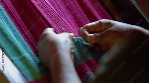 Indigenous woman weaving a blanket