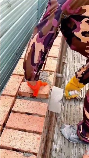 Precise Technique Laying Red Clay Bricks on a Construction Site