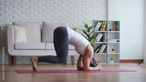 Calm of Attractive Asian woman practice yoga handstand pose to meditation in bedroom after wake up in the morning Feeling so comfortable and relax at home,Health care and Exercise at home Concept