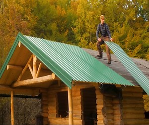 I am currently completing the installation of the metal roof on my log cabin while on my trip to the old property. | SOLO Boys
