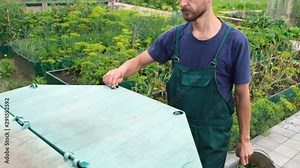 Farmer throws weeds and organic waste from his garden into compost heap. Composting - eco friendly recycling technology. Stock Video