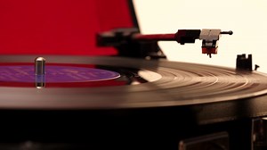 Record needle playing through LP album