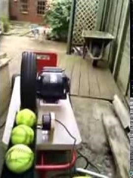 Home made slow-pitch softball pitching machine - trial in the garden