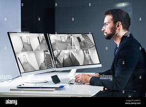 Security System CCTV Camera Operator Using Computer Monitor Stock Photo - Alamy