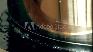 Boiling food in the pan. Water dripping on the hot cooking surface. 4K close-up video