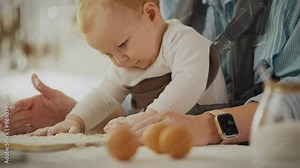 Food. A caring parent using kitchen utensils prepares breakfast in the home kitchen. Steady camera movement Caucasian woman prepares pancake batter uses the latest sling for convenience, to hold