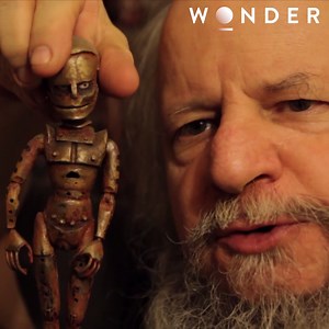 Michael is a 1960s Star Trek prop expert who has decided to turn his talents towards something quite unique. His home is crowded by repurposed dolls turned into unusual 'robots' which he then uses to star in stop-motion steamy movies. He's a character with a heart of weird, doll-loving gold. | The Wonder Channel