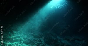 sun rays sun beams and sun shine underwater in cave beautiful light scenery in ocean scuba divers to see in cave backgrounds