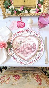 Two simple Valentine table glow-ups!!!! 🩷❤️ ........ I added some fun changes to my Valentine dining table this year, with two easy DIY'S. I had these pretty white lace chargers, and decided to take thin ribbon in red and pink and intertwine the cutouts, finishing with a pretty bow with long tails. I had also been wanting a green heart topiary as a centerpiece, but couldn't find one I liked. I had this red velvet heart with some minor dings that I thought would work, so I painted on some Mod Po