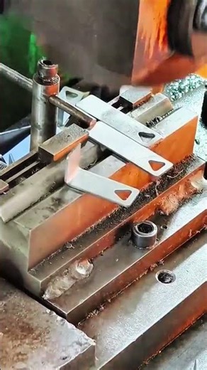 Worker ensures clean finishing during milling machine task