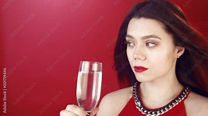 Drunk upset lonely girl with a glass of champagne. Red lips, gentle makeup on the face of a blonde. Drinks alone. Sadness on the face of the soup.