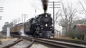 SCL / L&N Family Lines Rail System operated C&O 4-8-4 Greenbrier steam locomotive # 614, is seen leading the southbound Safety Express passenger train as it passes through the downtown area of Stark, Florida, February, 1981