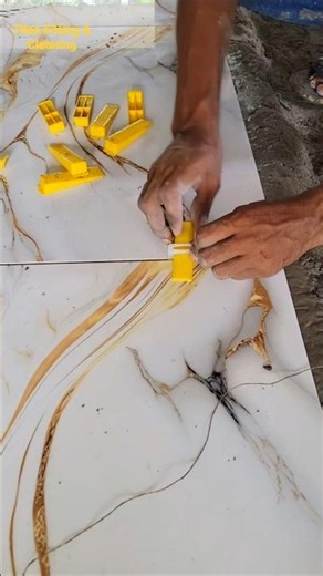 When laying tiles on the floor, using spacers at the tile joints helps the tiles lay straight.#floor