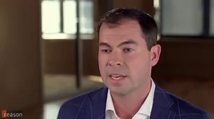 John Stossel got an eyeglass prescription over the internet. A company, Opternative, invented an at-home test. It's cheaper and more convenient than traditional eye exams. But the American Optometric Association wants that banned. Everyone who wants glasses should go to an eye doctor, says the association. Is this new eye test dangerous? Or is it a cheap and efficient eye care alternative? | Reason Magazine