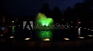 fountain water jets in the dark. Play of water jets and light. Light water performance.City fountain.