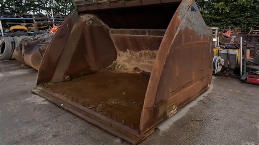 Massive 6-ton Caterpillar loader bucket ready for fabrication repair