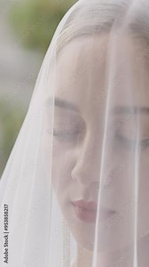The bride in a white dress and a transparent veil. Action. Beautiful women who pose with thoughtful and sad faces.