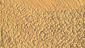 top view of yellow sand on the seabed. motion of water waves with sand texture. background, wallpaper