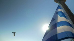 Greek flag waving in the wind on sky background