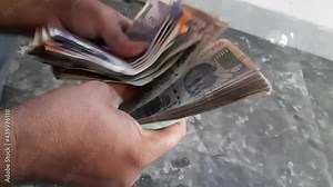 Counting old rupee one hundred notes rapidly, Closeup of a man counting rupee one hundred notes Indian currency.