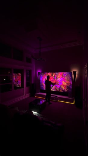 Dennis Anca on Instagram: "Immersive Home Theatre Projector Lighting is Next Level! 🍿 A lot of you asked me how I got this synchronized lighting setup in my home theatre, especially since I didn’t use a TV backlight..because this isn’t a TV! The Hisense PX3 Pro UST projector combined with this motorized screen and Projector Cabinet required me to get creative in order to achieve my desired lighting effect. 👀 I installed a Govee strip light under the cabinet, and some bulbs in the fixtures and 