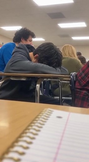 A student secretly films their friend sleeping during a boring lecture when suddenly the friend jolts awake and screams something completely random. The entire classroom erupts into uncontrollable laughter as the teacher looks on in confusion. | Caughtoncamai