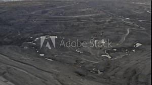Panorama aerial view shot, open pit mine, coal mining, dumpers, quarrying extractive industry, stripping work. View from drone at opencast mining with lots of machinery trucks