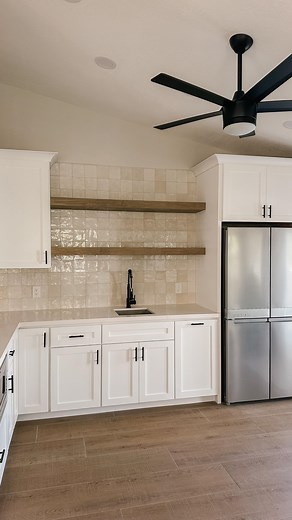 Our Arizona kitchen addition is finally complete and we couldn’t be more in love with how it all came together. From the start, our vision was to create a bright, modern space with timeless character — a perfect balance of clean lines and warm textures. The handcrafted tile backsplash adds just the right amount of subtle shine, while the floating wood shelves bring in natural warmth and depth. Paired with fresh white cabinetry, matte black fixtures and sleek appliances, this space feels both ele