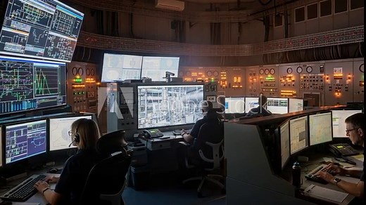 Control Room Operators Monitoring Multiple Screens with Surveillance Footage and Data Analytics in a High-Tech Command Center Environment