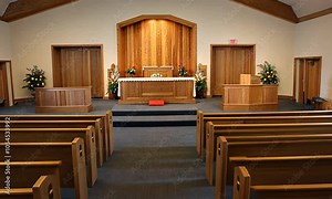 Empty wooden pews in a church sanctuary