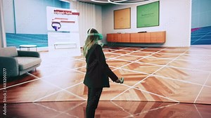 Interior Designer Using a VR Software to Design a Living Space. Change Couch Colors, Move Furniture in Interactive Environment on a Big Digital Screen. Female Engineer Using Headset and Controllers.