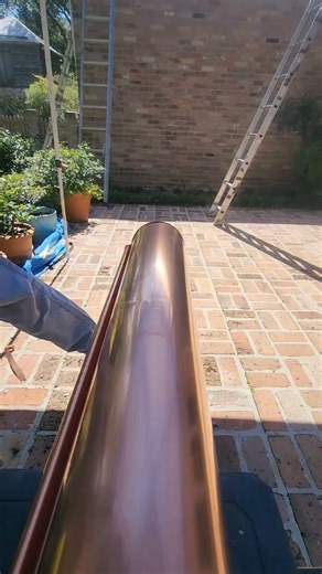 Josh on Instagram: "This is a little different type of outlet that I am installing today. 😁🤙 #not #soldering #copper #halfround #gutters #coppergutters #copperwork #handwork #bluecollar #roofersofinstagram"