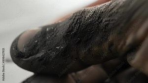 Coal miner's dirty hand shows the gritty work in a mine, highlighting challenges faced by workers