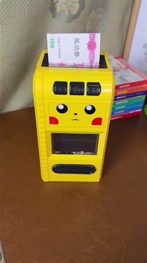 This is an electronic Pikachu-themed money bank, likely a model from the "Itazura" line.