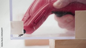 Using a glue gun to glue plexiglass. Waterproofing cracks with hot glue