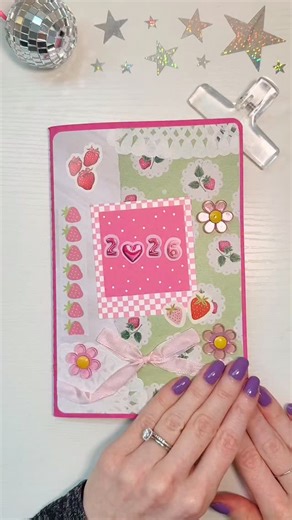 laura t ✿ on Instagram: "my #yearinpixels spread! 🎀✨ i’ll be ranking each day this year from 1-5 stars + coloring in the corresponding color! hoping to look back on 2026 + see lots of deeper pinks ☺️ the “2026” is made up of 365 squares that i mapped out on dot paper! (stamped out each individual date off camera 🤣) used the @lovepipsticks dream vision collage magazine for the cutest letter stickers! do you include this spread in your journal? 💗 #creativejournal #journalwithme #journalsetup #j