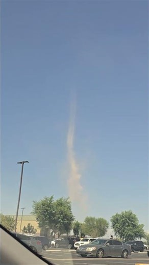 Towering Dust Devil Swirls Over Parking Lot