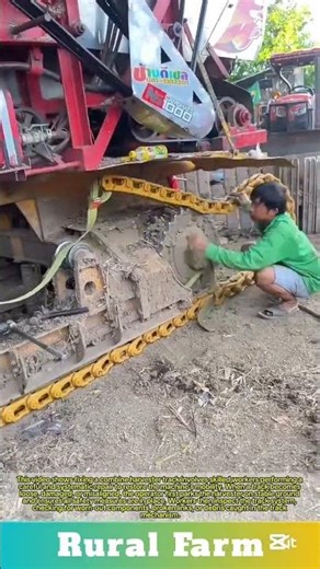 Fixing a combine harvester track: skilled workers performing a careful and systematic repair
