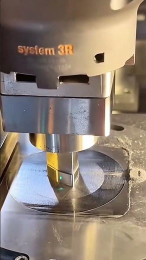 A CNC machine is precisely milling a circular metal surface
