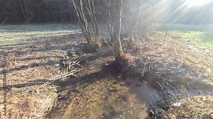Frozen stream with ice floes and water