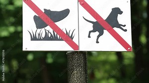 Dogs prohibition sign. Plate on post in city park - forbidden to walk on lawns and no dogs allowed