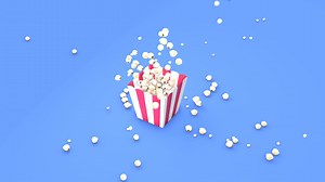Download Animated Popcorn falling from above filling out red and white striped bucket with slow motion in the middle of the animation for free