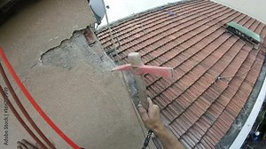 High Rise Worker Restoring Infiltration Scraping External Wall,Point of View