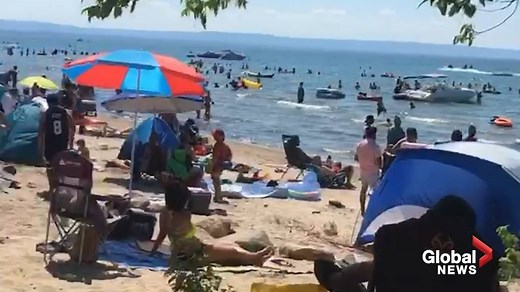 Crowds breaking physical distancing rules at Wasaga Beach on Canada Day